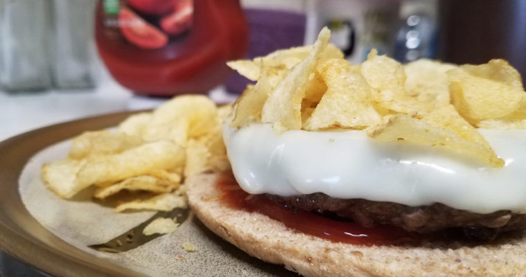 Cheeseburger and chips on bread thin
